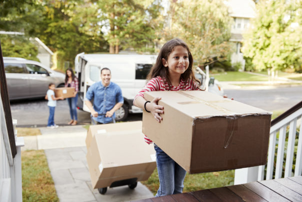 Children moving boxes into new home