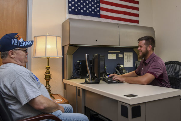 Mike Ellis, retired Air Force veteran, speaks to Daniel Desler, Disabled American Veterans, at the 375th Medical Group building at Scott Air Force Base, Ill. July 9, 2019. The DAV assists active duty, veterans, and retirees with the VA claims process, and can help with compensation and pension. It is a free service and the team works as a liaison between the military and VA.(U.S. Air Force photo by Senior Airman Chad Gorecki)