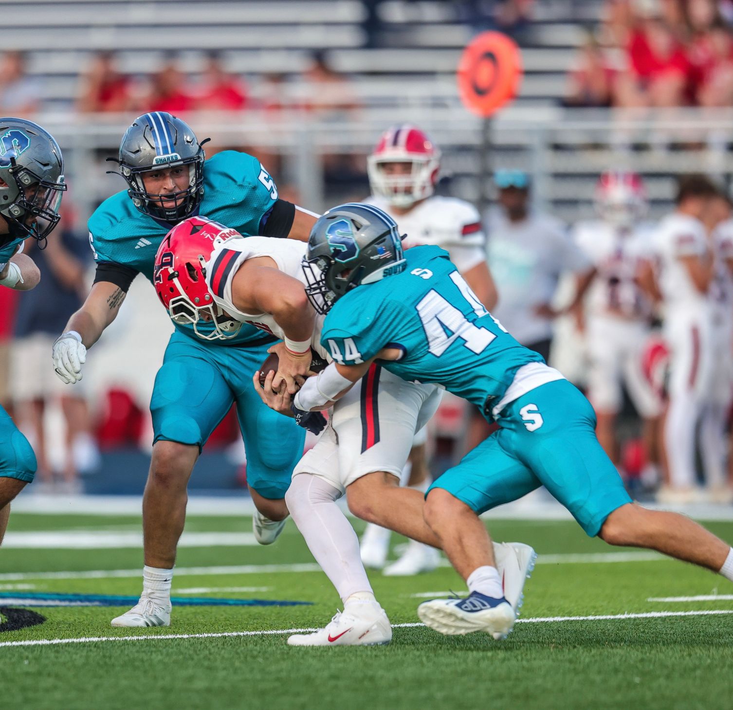 Jaik Chadwick, #44, works to loosen the grip a Notre Dame High School Pioneers football player has on the ball during a game at the new Southside High School stadium, The Reef,  on Sept. 5, 2025, in Youngsville, Louisiana.